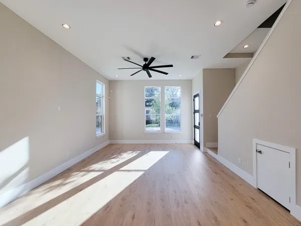 wooden floor in an empty room with a window