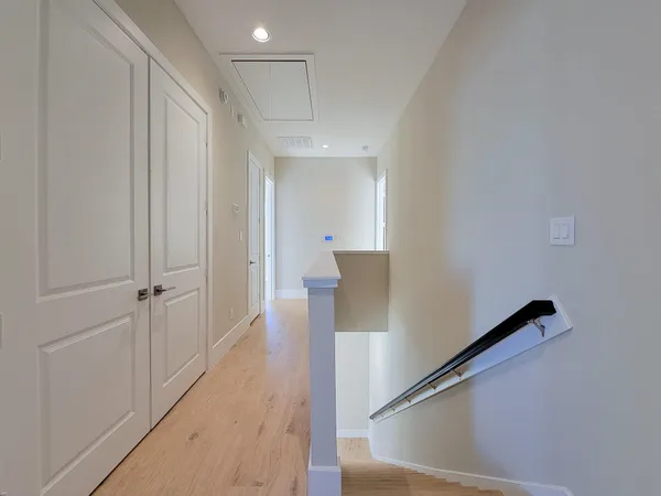 a view of a hallway with wooden floor
