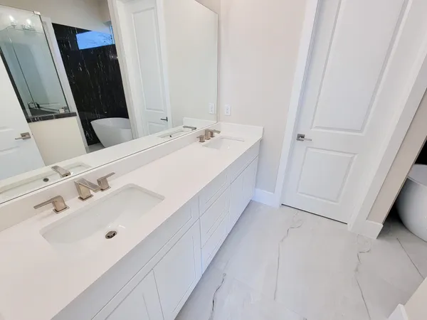 a bathroom with a double vanity sink and a mirror