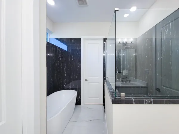 a bathroom with a tub and shower