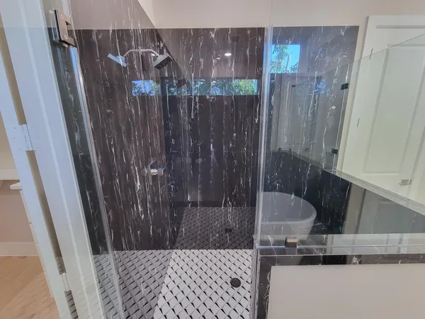 a bathroom with a shower and a sink