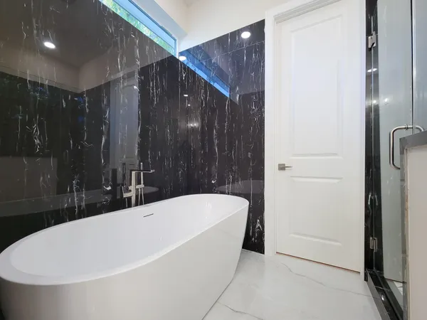 a bathroom with a bathtub and shower