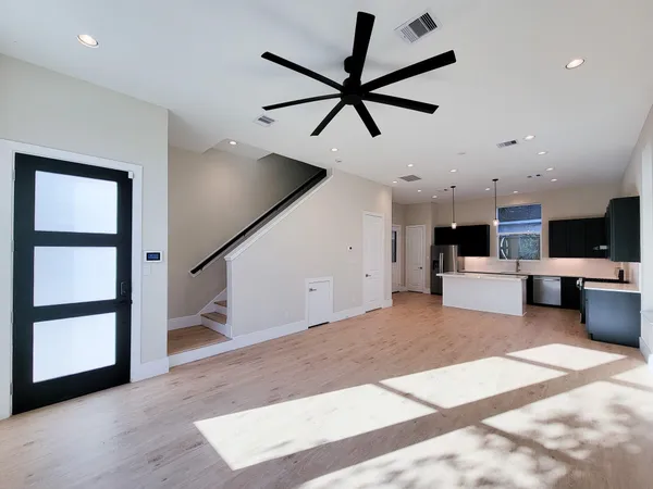 a view of a kitchen with furniture and a ceiling fan