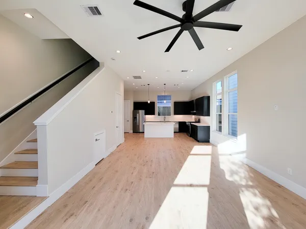 a view of living room with furniture and a ceiling fan