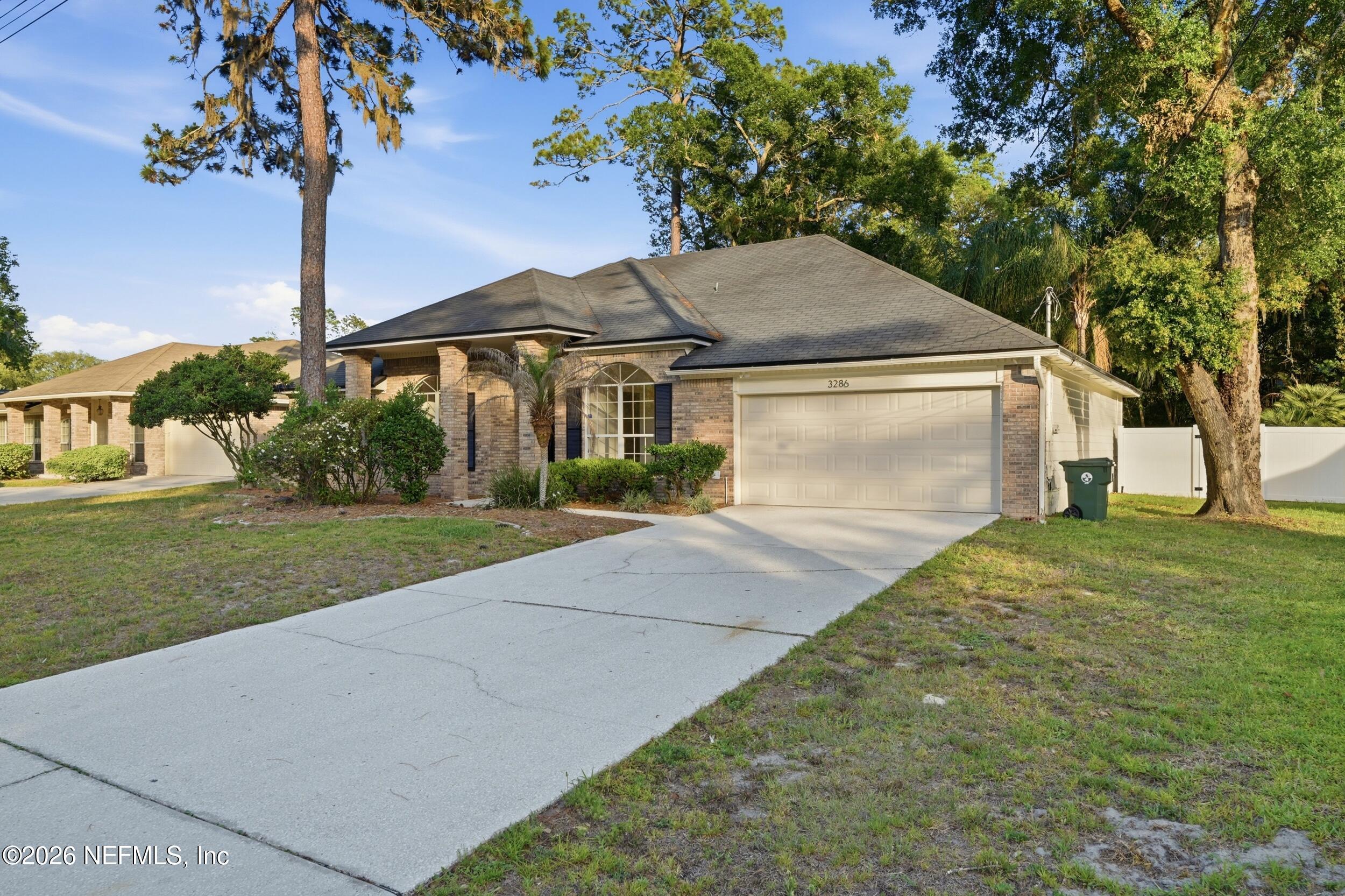 3286 Marbon Road Jacksonville, FL 32223 - Photo 1 of 36 a front view of a house with garden