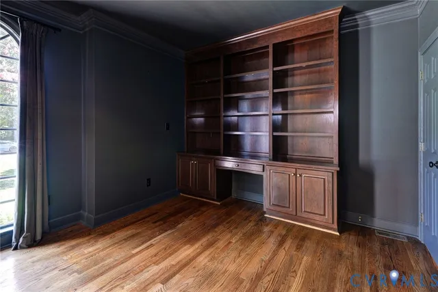 a kitchen with a wooden floor and a window
