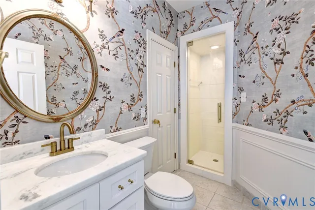 a bathroom with a granite countertop sink mirror vanity and toilet