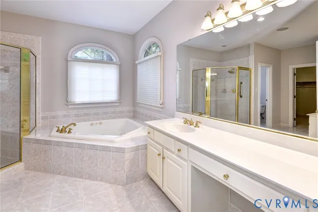a spacious bathroom with a tub a double vanity sink and a mirror