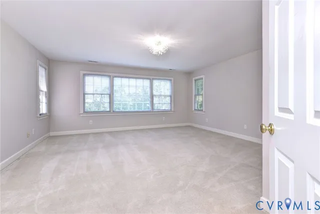 an empty room with windows and closet