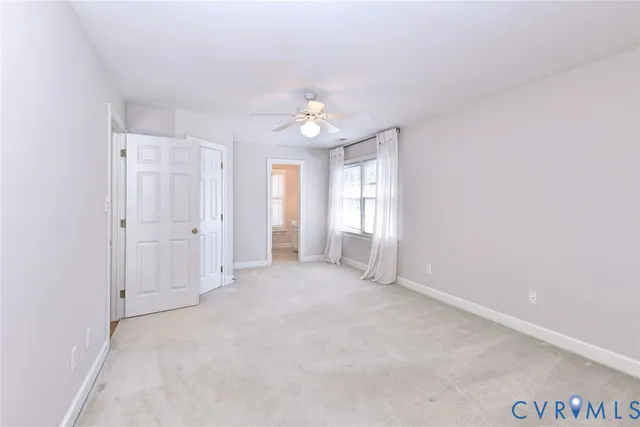 an empty room with windows and cabinet