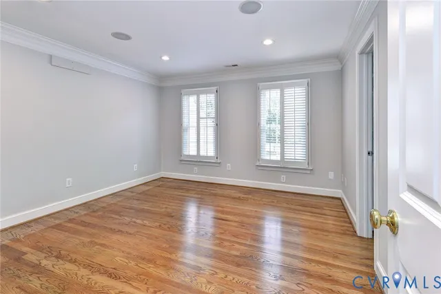 a view of staircase with railing and white walls