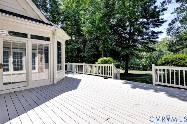 a balcony with wooden floor and fence