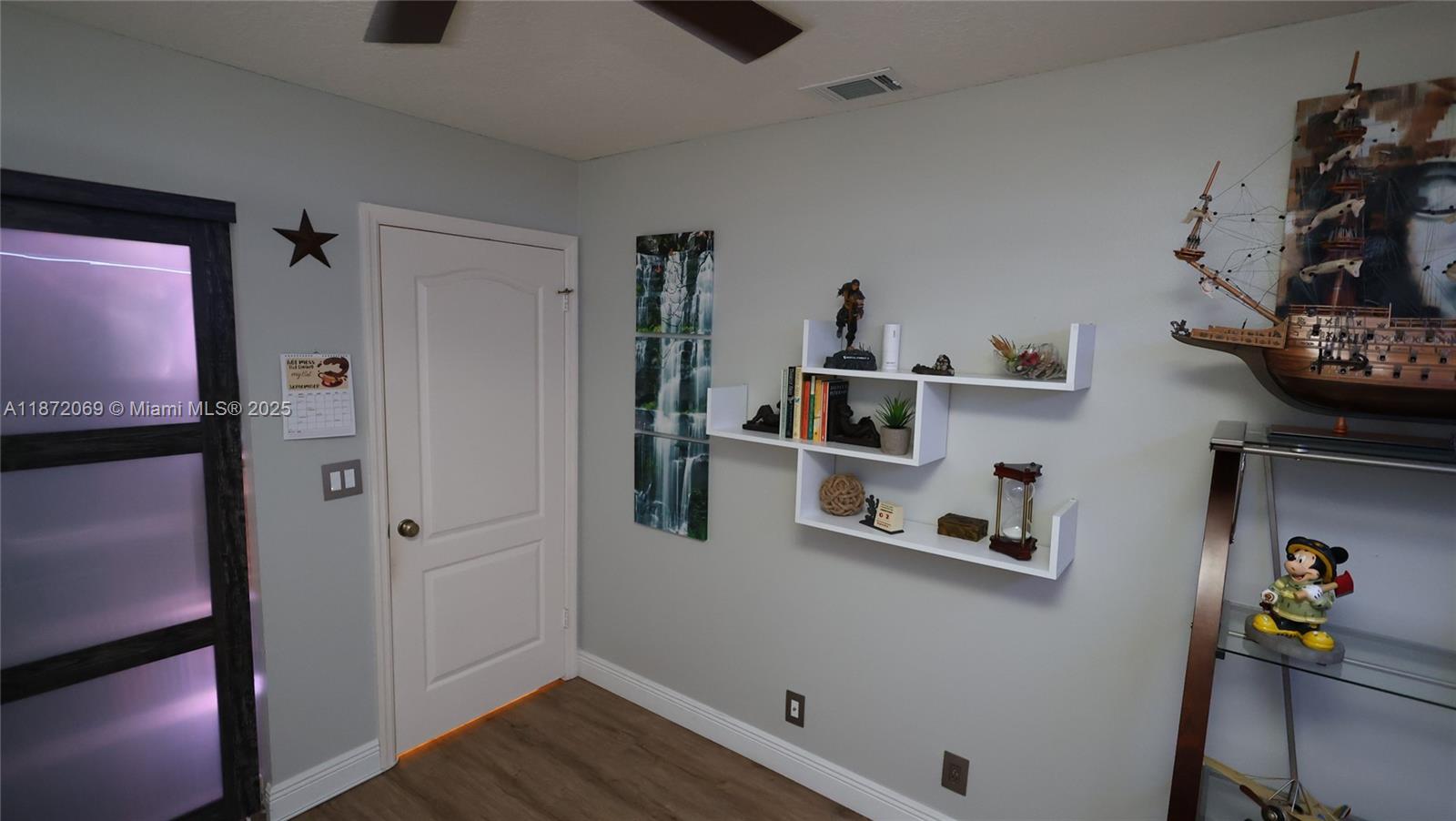 11251 Reveille Road Cooper City, FL 33026 - Photo 23 of 82 a view of storage and utility room with wooden floor and fan