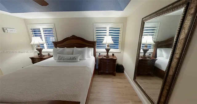 a view of a hallway with wooden floor and closet