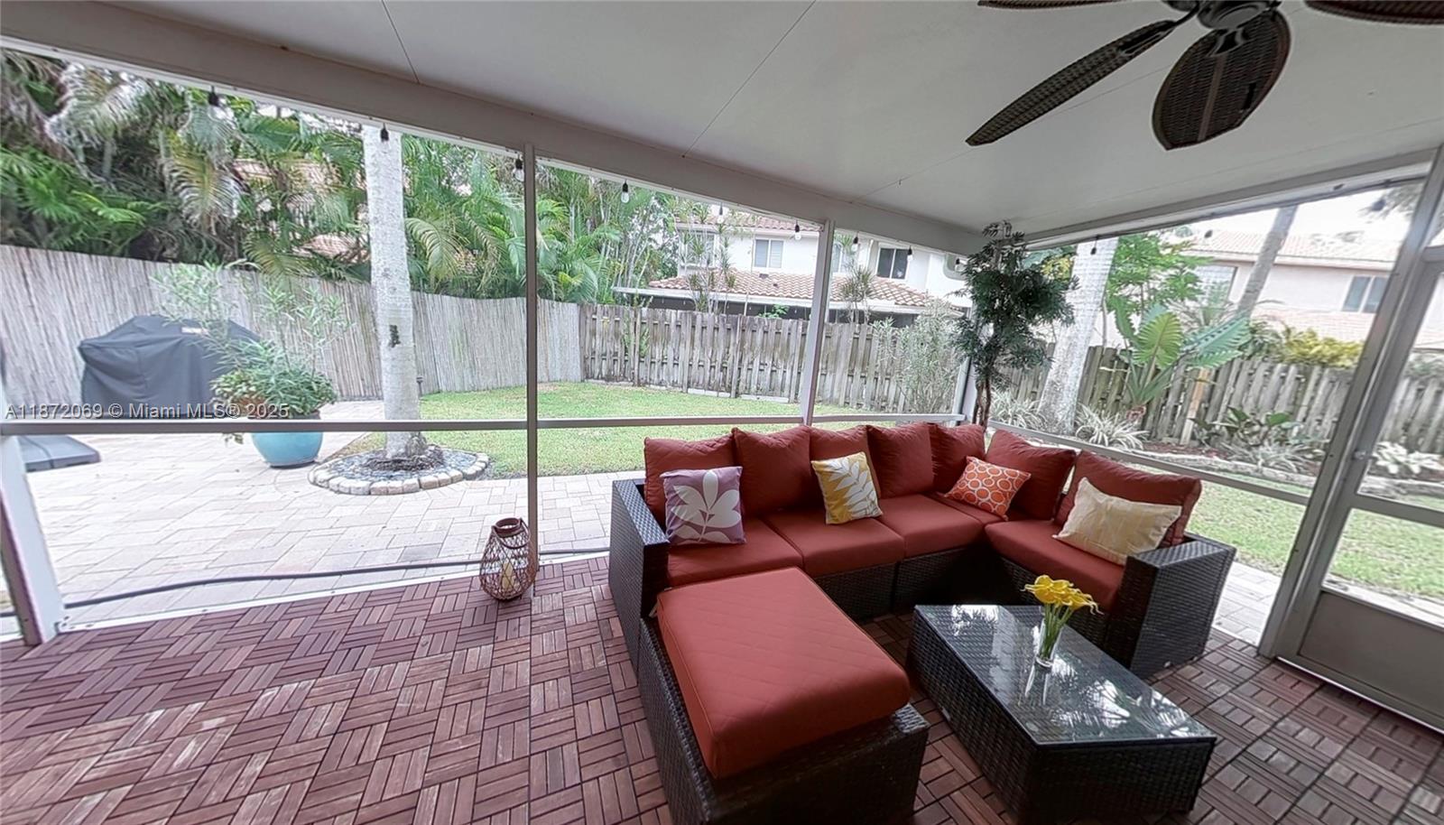 11251 Reveille Road Cooper City, FL 33026 - Photo 45 of 82 a living room with furniture and a floor to ceiling window