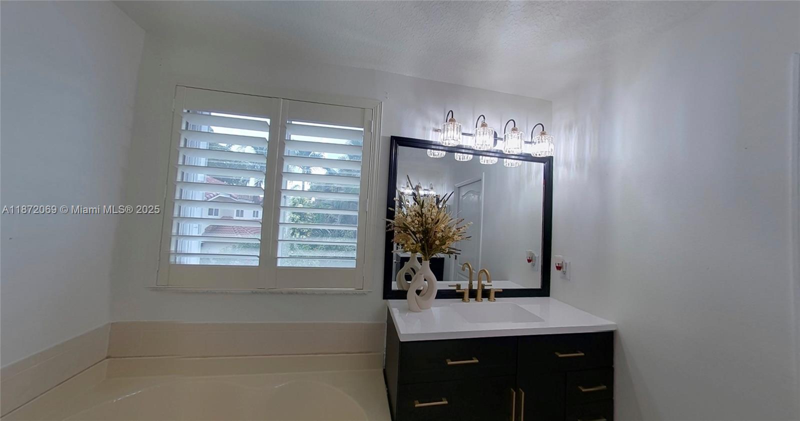 11251 Reveille Road Cooper City, FL 33026 - Photo 7 of 82 a bathroom with a sink a vanity and a mirror