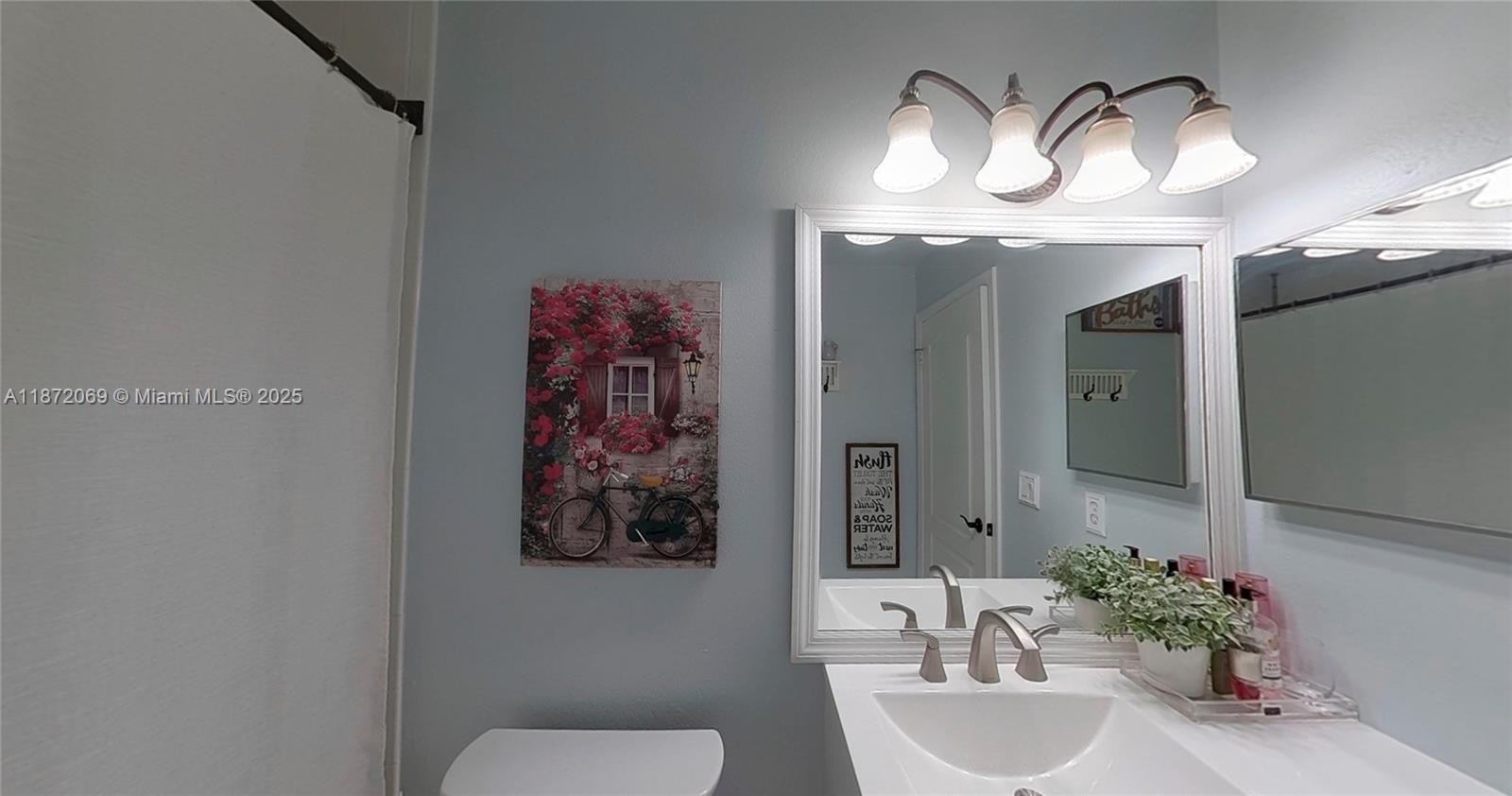 11251 Reveille Road Cooper City, FL 33026 - Photo 10 of 82 a bathroom with a sink and a mirror