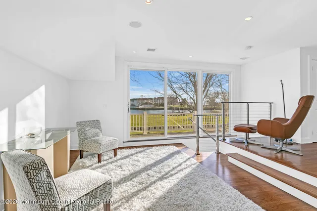 a living room with furniture and a floor to ceiling window
