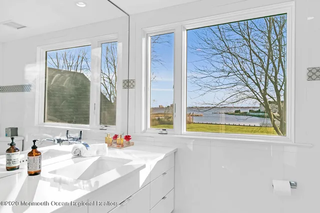a bathroom with a tub sink and mirror