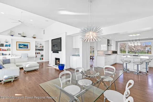 a living room with fireplace furniture and a large window