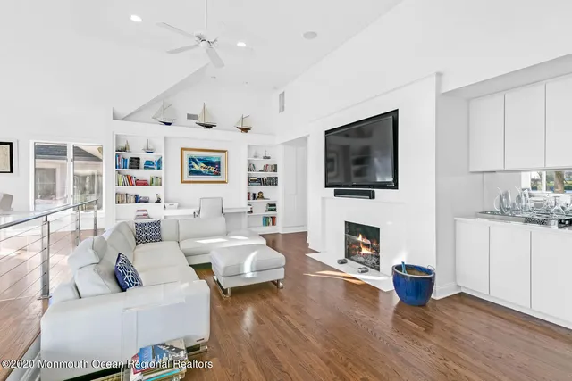 a living room with fireplace furniture and a flat screen tv