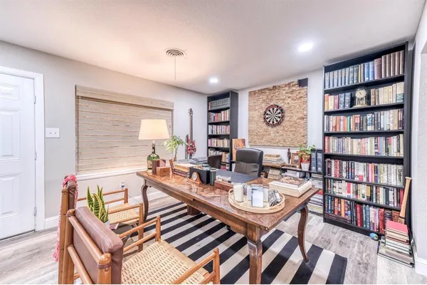 a living room with furniture and a book shelf