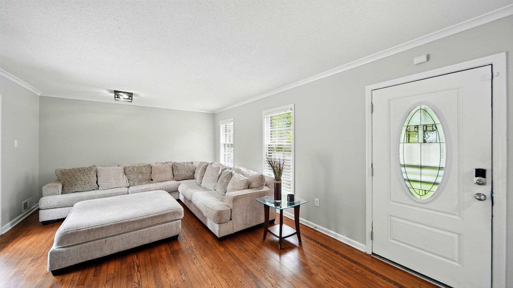359 South Fenwick Road Memphis, TN 38111 - Photo 7 of 31 Living room featuring dark wood-style flooring, ornamental molding, and a textured ceiling