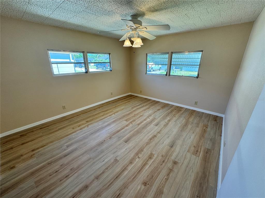 2331 Belleair Road, Unit LOT 237 Clearwater, FL 33764 - Photo 14 of 33 a view of empty room with wooden floor and fan