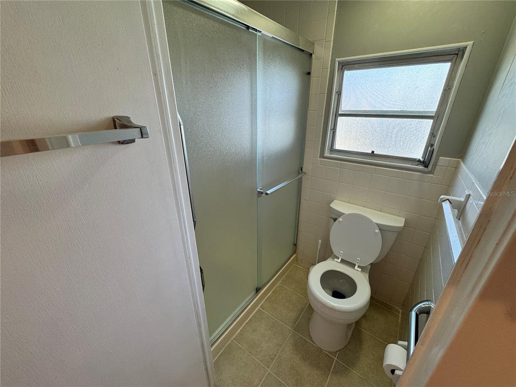 2331 Belleair Road, Unit LOT 237 Clearwater, FL 33764 - Photo 16 of 33 a bathroom with a toilet and a shower