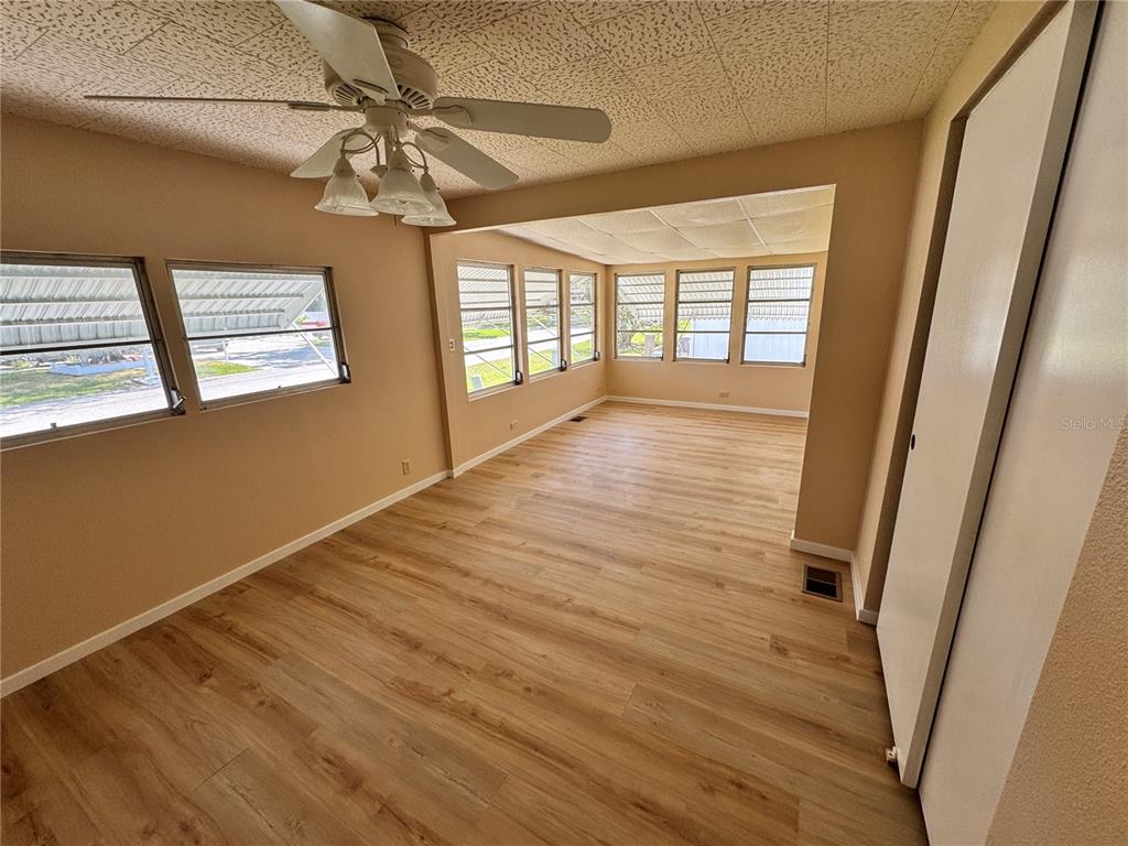 2331 Belleair Road, Unit LOT 237 Clearwater, FL 33764 - Photo 17 of 33 a view of an empty room with wooden floor and a window