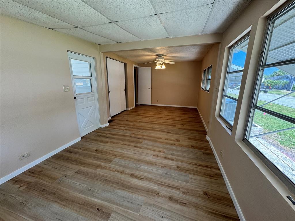 2331 Belleair Road, Unit LOT 237 Clearwater, FL 33764 - Photo 18 of 33 a view of an empty room with wooden floor and a window