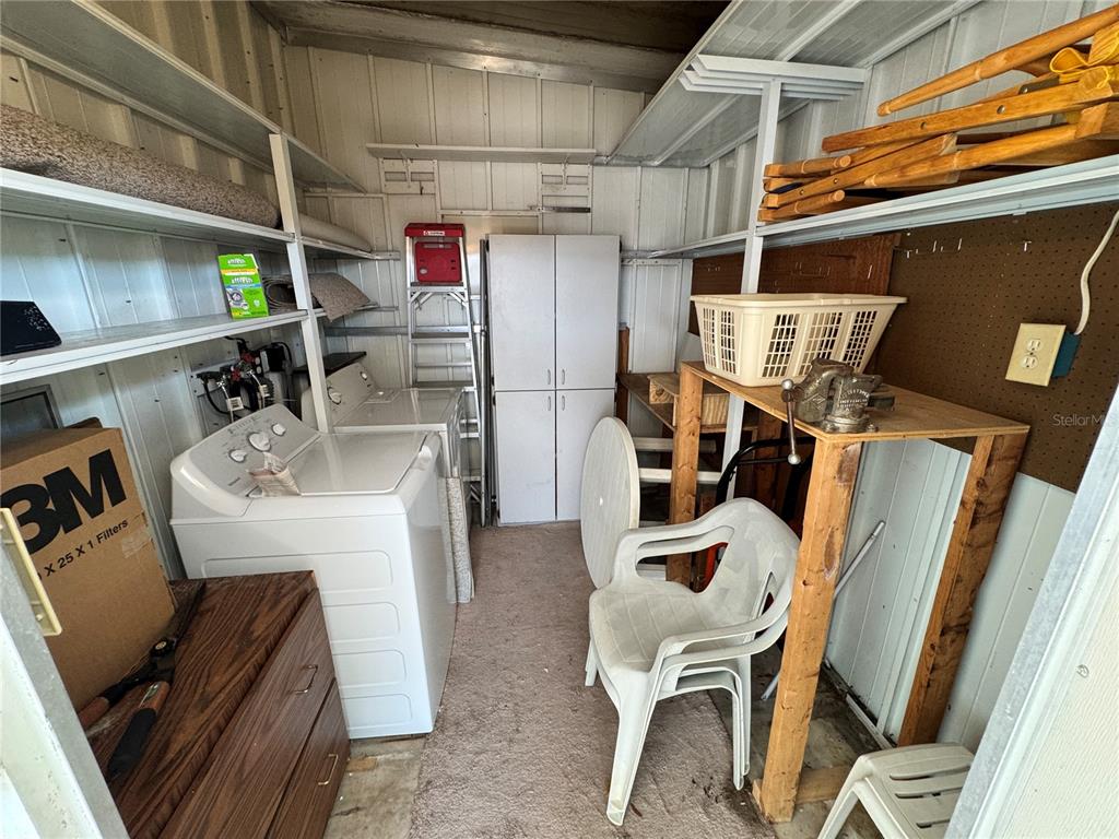 2331 Belleair Road, Unit LOT 237 Clearwater, FL 33764 - Photo 23 of 33 a storage room with washer and dryer