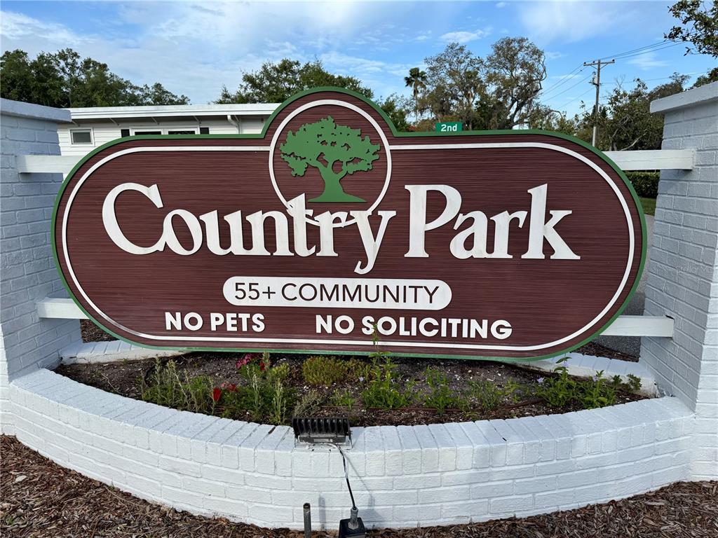 2331 Belleair Road, Unit LOT 237 Clearwater, FL 33764 - Photo 24 of 33 a sign that is on top of street