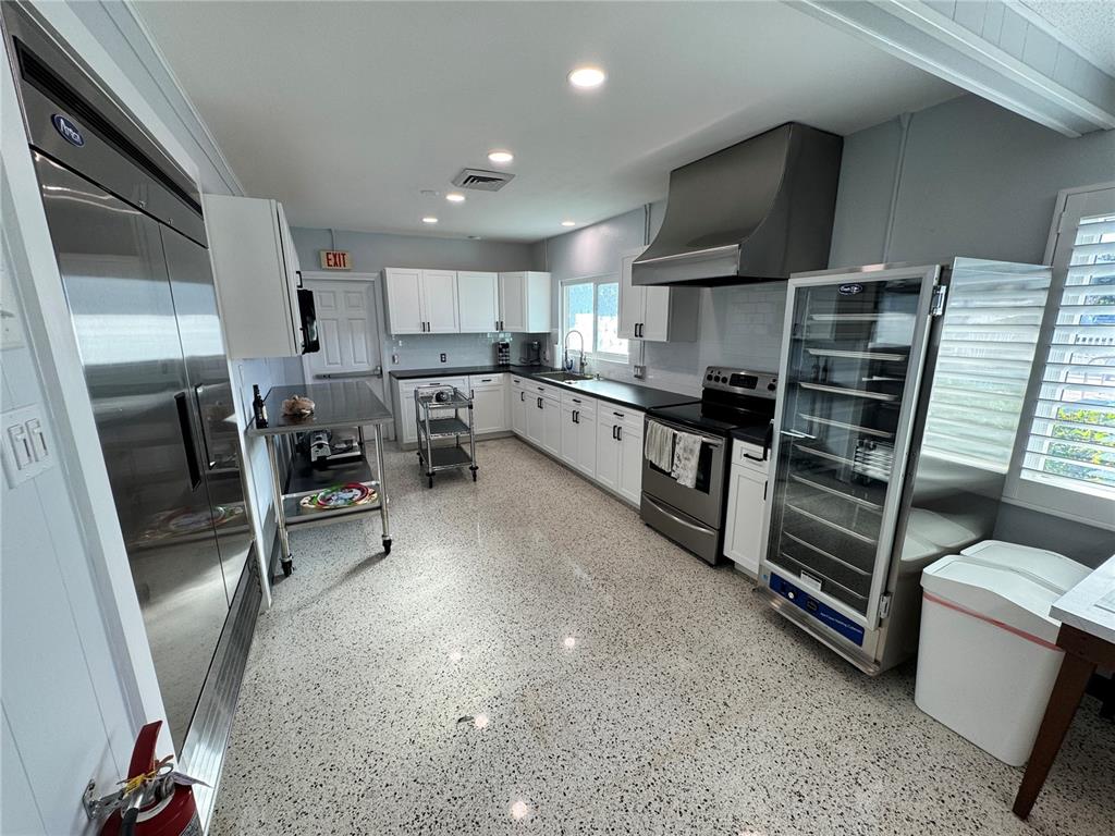 2331 Belleair Road, Unit LOT 237 Clearwater, FL 33764 - Photo 29 of 33 a kitchen with stainless steel appliances a stove a refrigerator and a sink