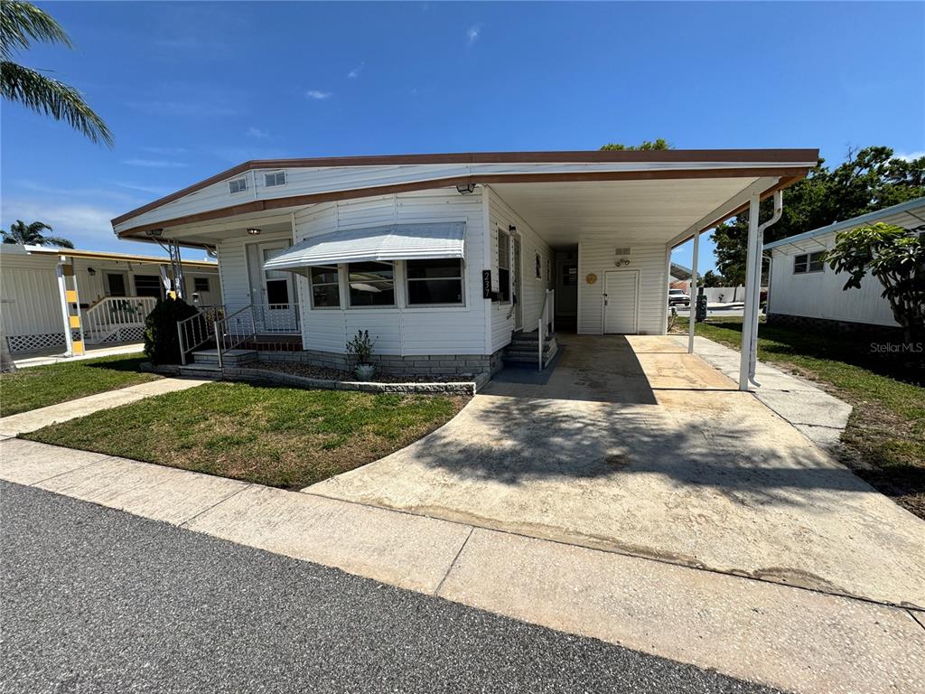 2331 Belleair Road, Unit LOT 237 Clearwater, FL 33764 - Photo 3 of 33 a view of a house with a yard