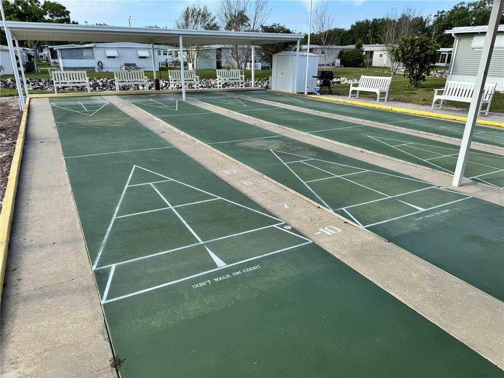 2331 Belleair Road, Unit LOT 237 Clearwater, FL 33764 - Photo 33 of 33 a view of a tennis ground with large trees