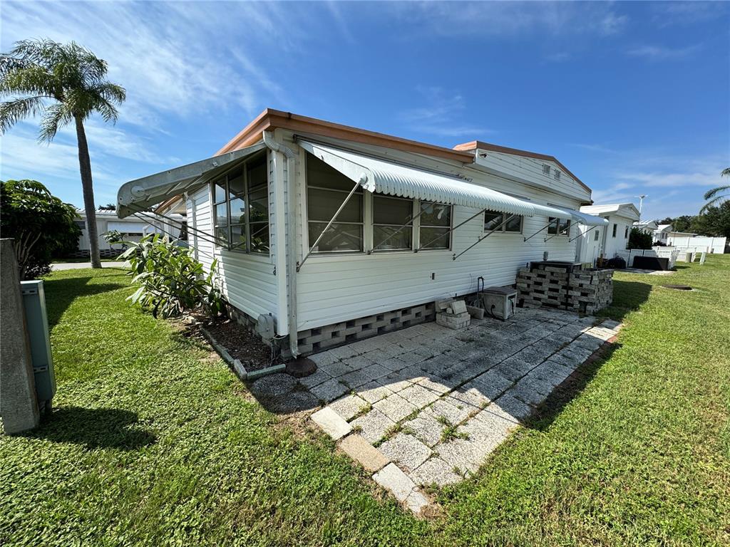 2331 Belleair Road, Unit LOT 237 Clearwater, FL 33764 - Photo 5 of 33 a front view of a house with a yard