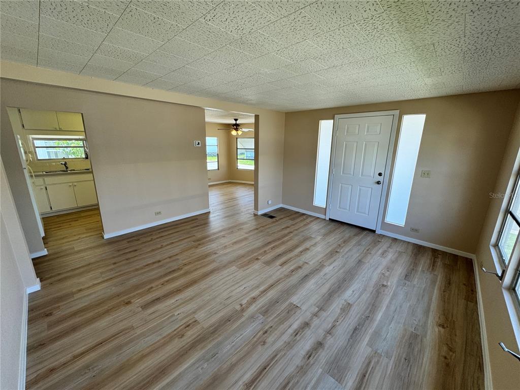 2331 Belleair Road, Unit LOT 237 Clearwater, FL 33764 - Photo 8 of 33 a view of an empty room with wooden floor and a window