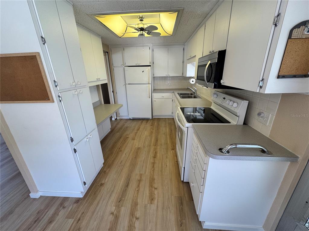 2331 Belleair Road, Unit LOT 237 Clearwater, FL 33764 - Photo 9 of 33 a kitchen with white cabinets and sink