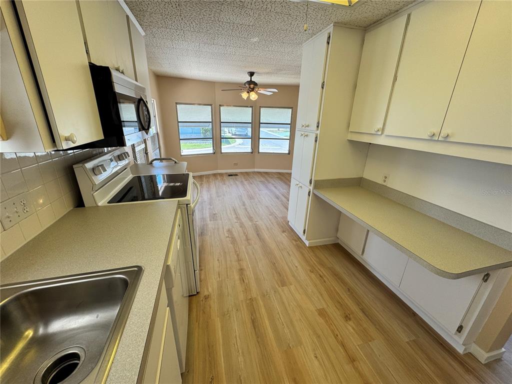 2331 Belleair Road, Unit LOT 237 Clearwater, FL 33764 - Photo 10 of 33 a view of a kitchen with wooden floor and staircase