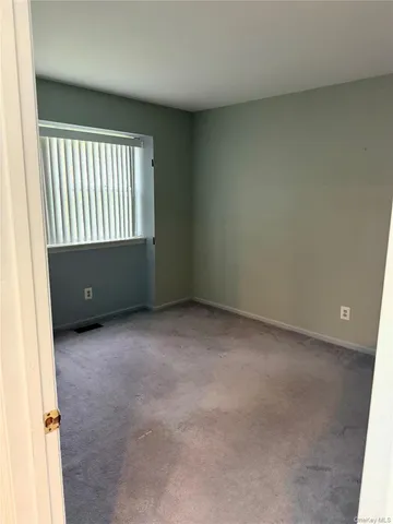an empty room with closet area