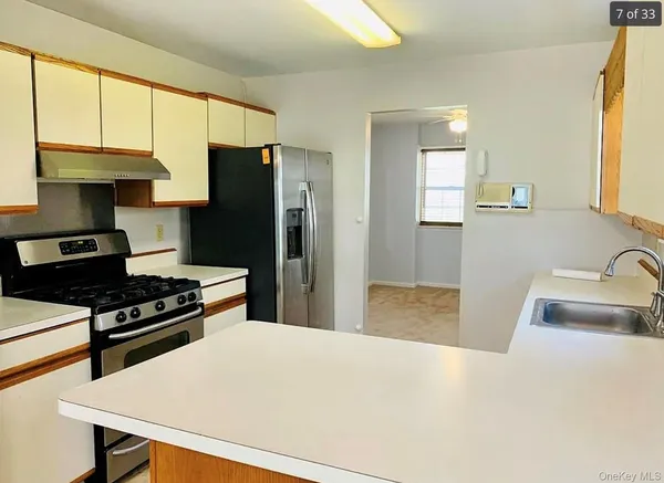a kitchen with a stove a refrigerator and a sink