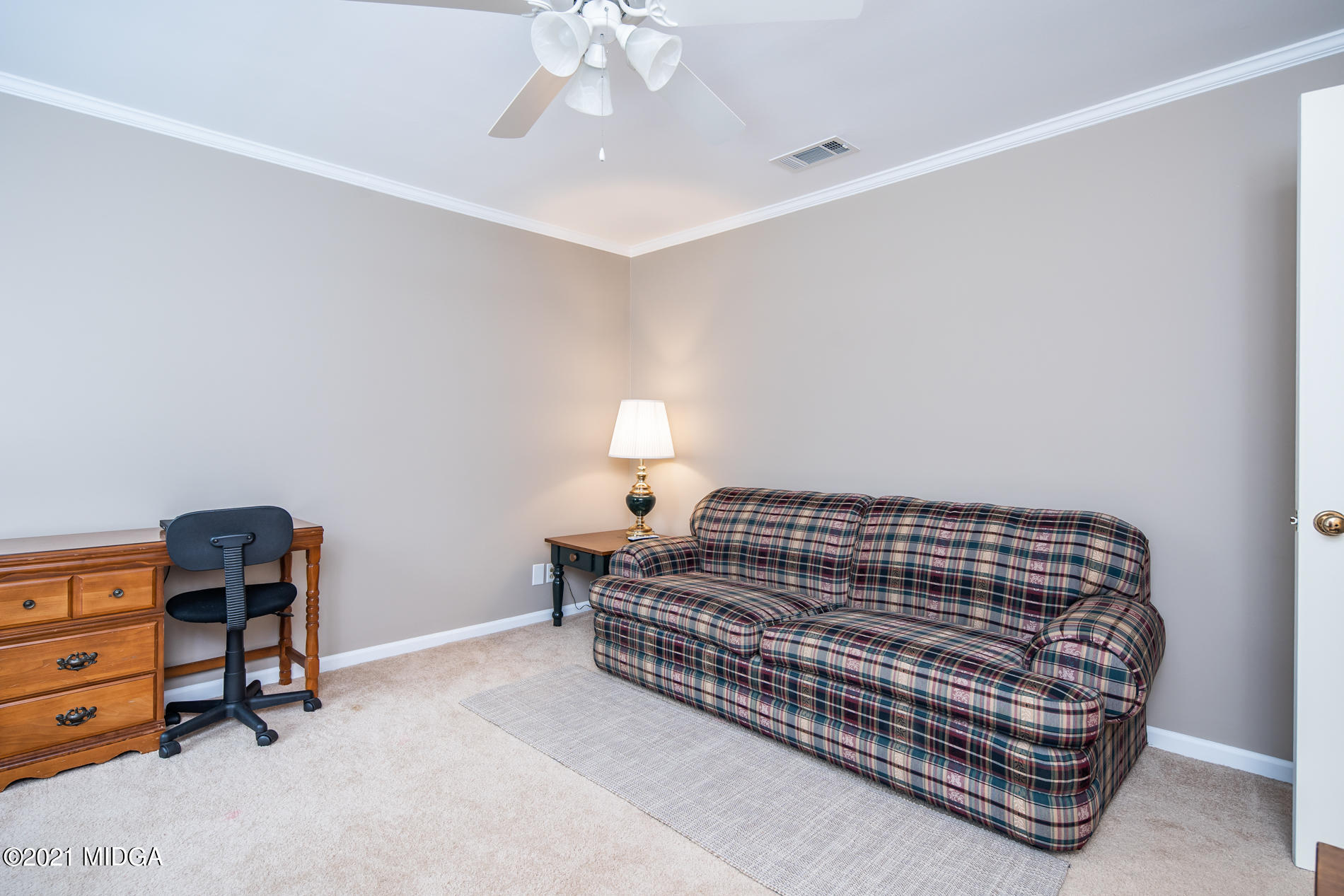 155 Castlegate Road Macon, GA 31210 - Photo 26 of 34 a bedroom with a bed and a chandelier