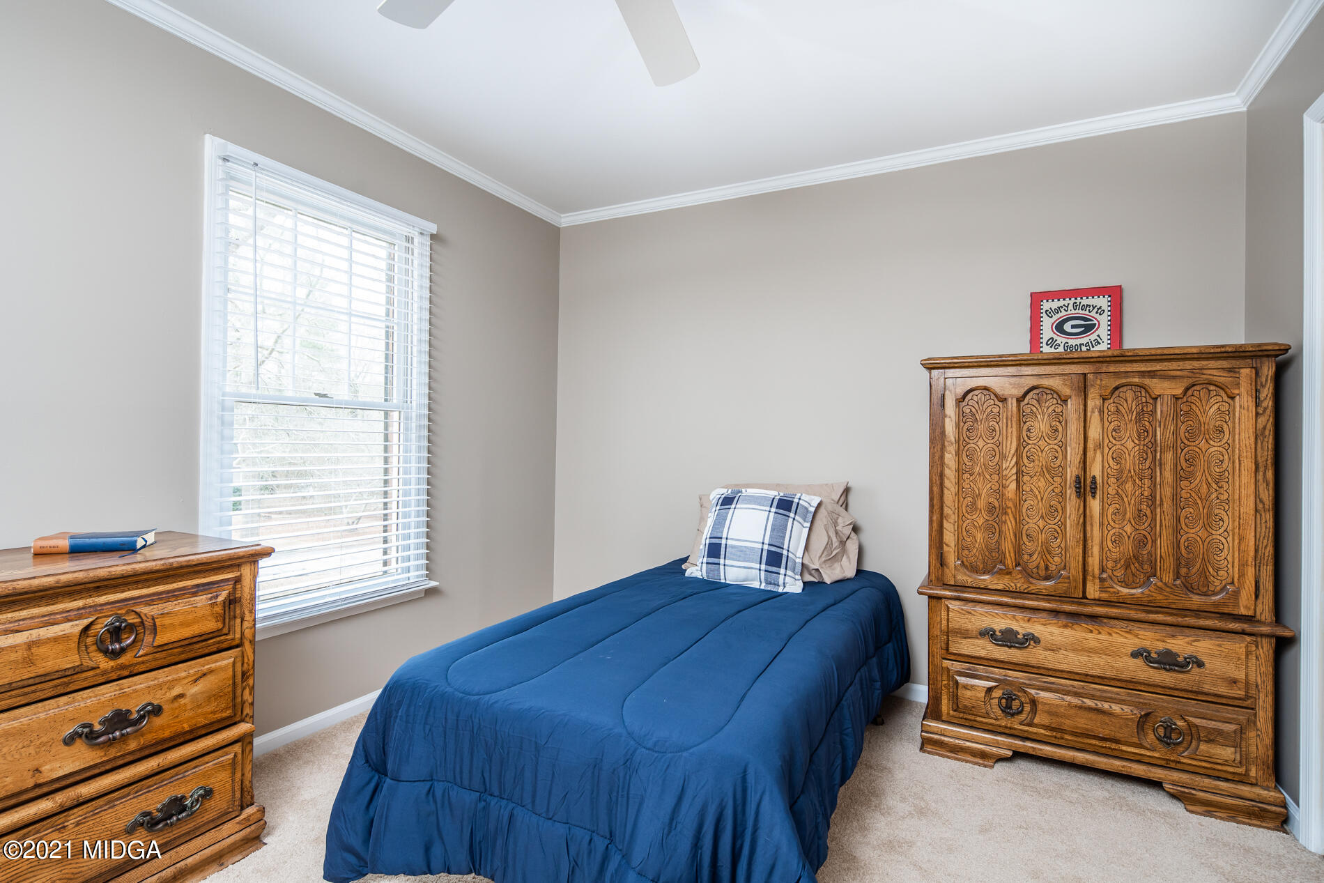 155 Castlegate Road Macon, GA 31210 - Photo 28 of 34 a bedroom with a bed and wooden cabinets