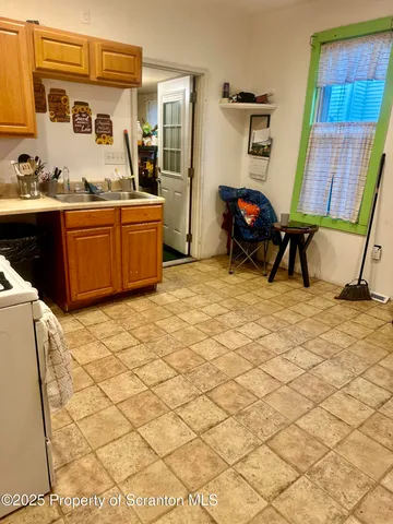 a living room with a washing machine and sink