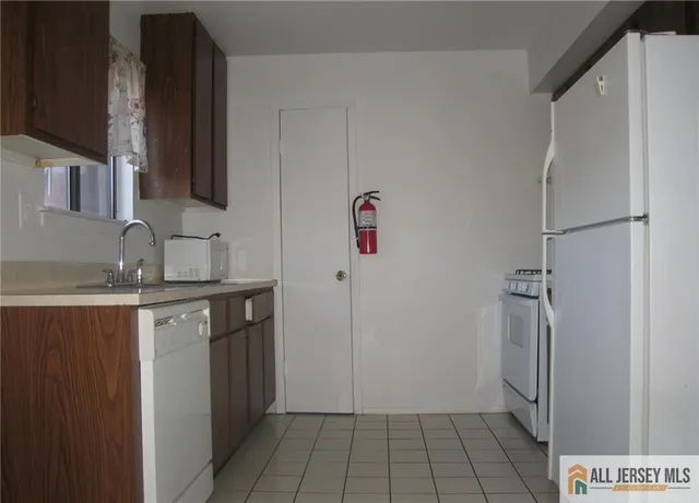 a bathroom with a granite countertop sink a mirror and shower