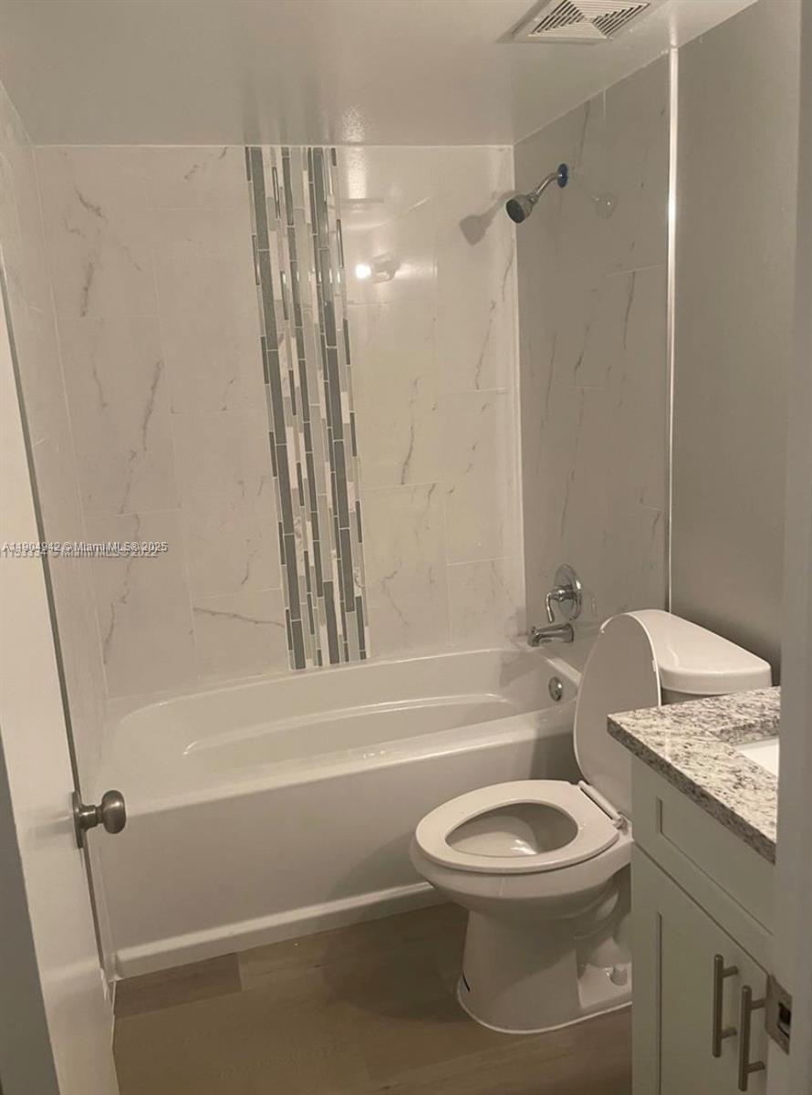 3252 Foxcroft Road, Unit 314 Miramar, FL 33025 - Photo 4 of 9 a bathroom with a toilet a sink and bathtub