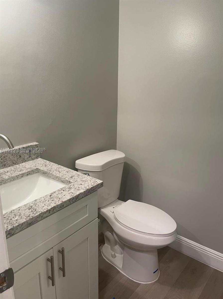 3252 Foxcroft Road, Unit 314 Miramar, FL 33025 - Photo 5 of 9 a white toilet sitting next to a bathroom sink