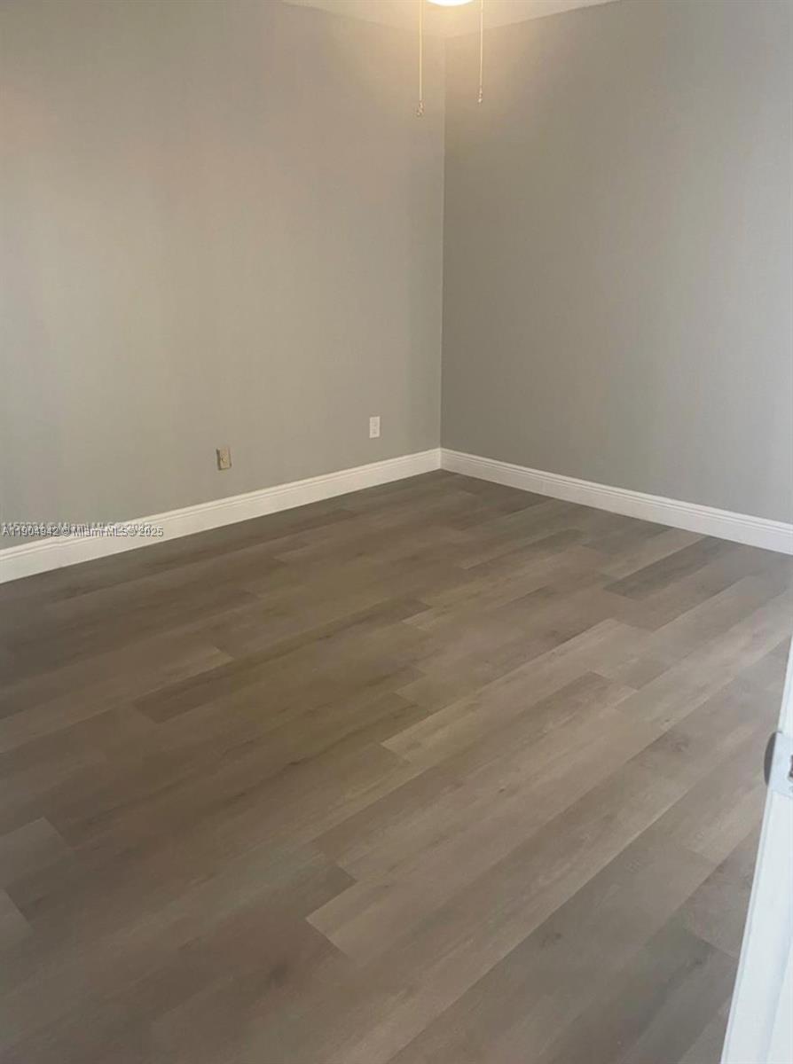 3252 Foxcroft Road, Unit 314 Miramar, FL 33025 - Photo 7 of 9 a view of an empty room with wooden floor