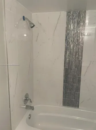 a kitchen with granite countertop a sink and cabinets